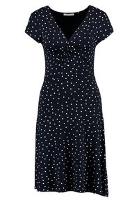 Robe marine à pois blancs, encolure en V, manches courtes et détail froncé à la taille. Fabriquée en tissu lisse et extensible.