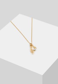 Guldsmykke med musiknoter som vedhæng og en lille klar ædelsten. Glat, skinnende overflade med en delikat kæde.