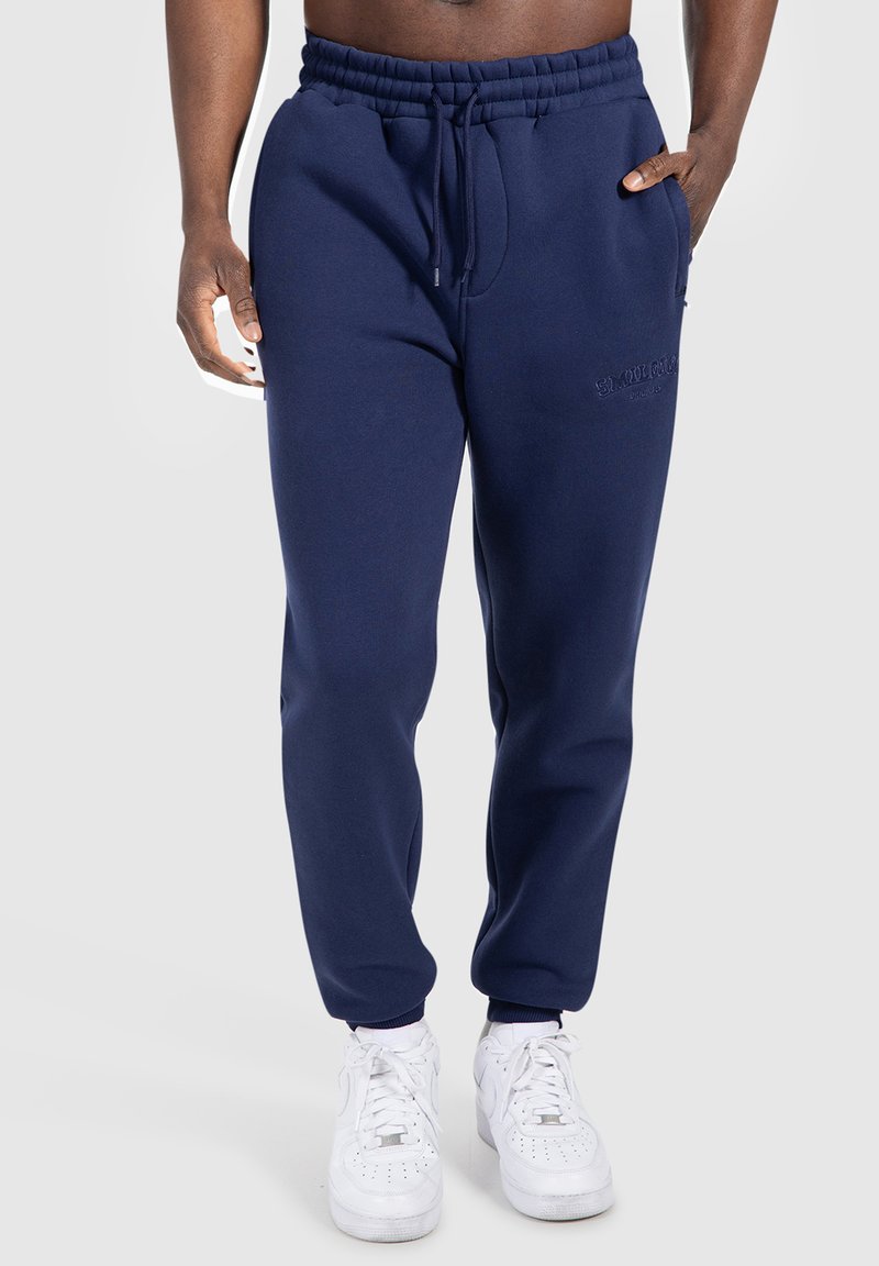Navyblaue Sweatpants mit elastischem Bund und Kordelzug, seitlichen Taschen und gerippten Bündchen. Gesticktes Logo-Detail.