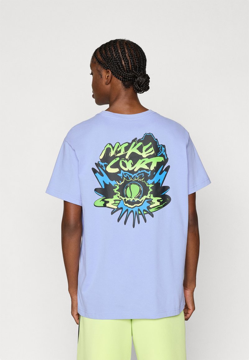 Ανοιχτό μωβ βαμβακερό μπλουζάκι με μεγάλο σχέδιο σε μαύρο, μπλε και νέον πράσινο, με το κείμενο "NIKE COURT" και θέμα τένις.