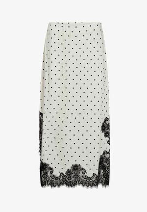 Falda midi blanca con lunares negros y ribete de encaje floral negro en el dobladillo y las costuras laterales.