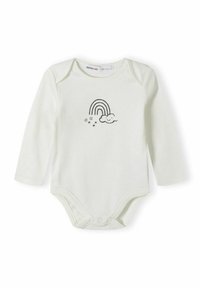 Combinaison à manches longues de couleur crème avec un motif imprimé représentant un arc-en-ciel, un nuage souriant et de petites étoiles. Fabriquée en tissu doux.