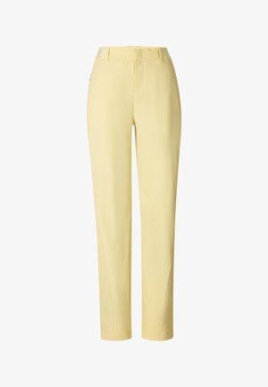 Proste, jasnżółte spodnie z szlufkami na pasek i zapięciem na zamek z przodu.