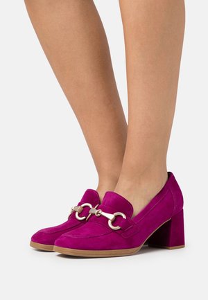 Chaussures à talons bloc en daim fuchsia avec un bout arrondi, ornées d'une chaîne décorative et d'une sangle sur le cou-de-pied. Texture lisse, conception robuste.