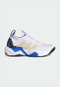 Sneaker sportivo bianco con strisce beige, dettagli blu e neri sulla suola e motivi decorativi neri nell'area del tallone.