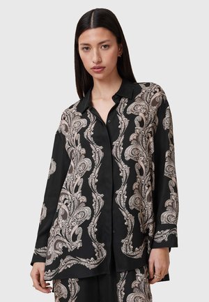 Camicia nera con motivo paisley in beige e bianco, realizzata in tessuto morbido, con colletto, bottoni e maniche lunghe.