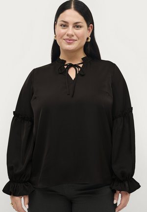Black blouse with a high neck, tie closure, and ruffled sleeves. Made from smooth fabric, featuring a slight sheen and a relaxed fit.