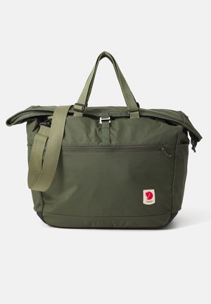 Olive green tote bag with dual handles and an adjustable shoulder strap. Features a main zippered compartment and a front zipper pocket.