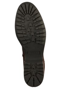 Czarna gumowa podeszwa z głębokim bieżnikiem i wzorami gwiazd, teksturowana dla lepszej przyczepności. W centrum znajduje się logo Tom's.