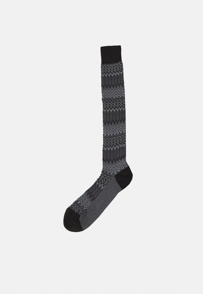 Black and gray knee-high sock with a zigzag pattern, contrasting solid black cuff and toe, and textured fabric for comfort.
