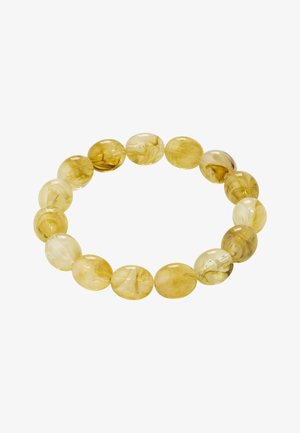 Stretch bracelet made of translucent oval beads with yellow and amber marbled patterns on a white background.