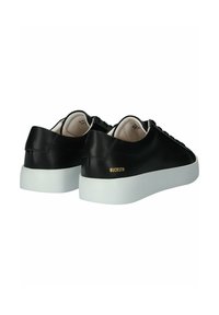 Black leather sneakers with a smooth texture, flat white rubber sole, and a subtle gold logo on the heel. Laced design with rounded toe.