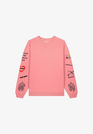 Pink sweatshirt with long sleeves. Features various graphic prints in black and colorful embellishments on the arms. Crew neck design.