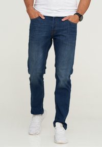 Unselected, distressed dark blue denim