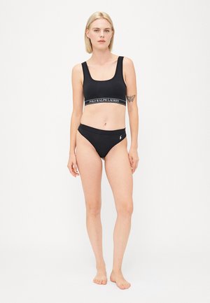 Black bikini set made of smooth fabric. Top features wide straps and logo band; bottom has a low-rise cut with a logo accent.