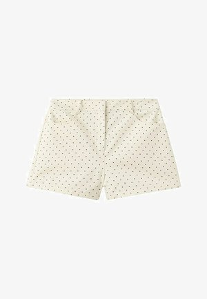 Shorts couleur crème avec petits pois noirs, poches avant et ceinture cousue.
