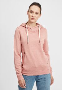 Felpa rosa con scollo incrociato, dettagli con cordoncino e tasche laterali con inserti triangolari marroni. Tessuto morbido con polsini a coste.