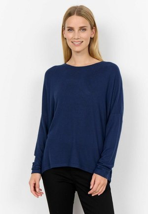 Navy blue long-sleeve top with a relaxed fit, round neckline, and soft texture. Features dropped shoulders and a curved hem design.