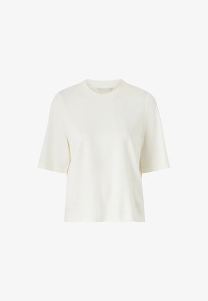 T-shirt à manches courtes et col rond en blanc cassé, fabriqué à partir d'un tissu lisse avec une coupe décontractée et un design discret. Sans motifs ni accents.