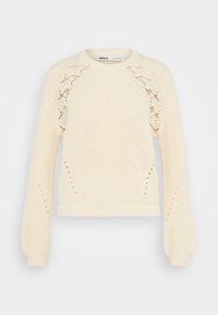 Kræmfarvet strikket sweater med rund halsudskæring, lange puffærmer og blonde mønsterdetaljer på skulderne. Struktureret stof.