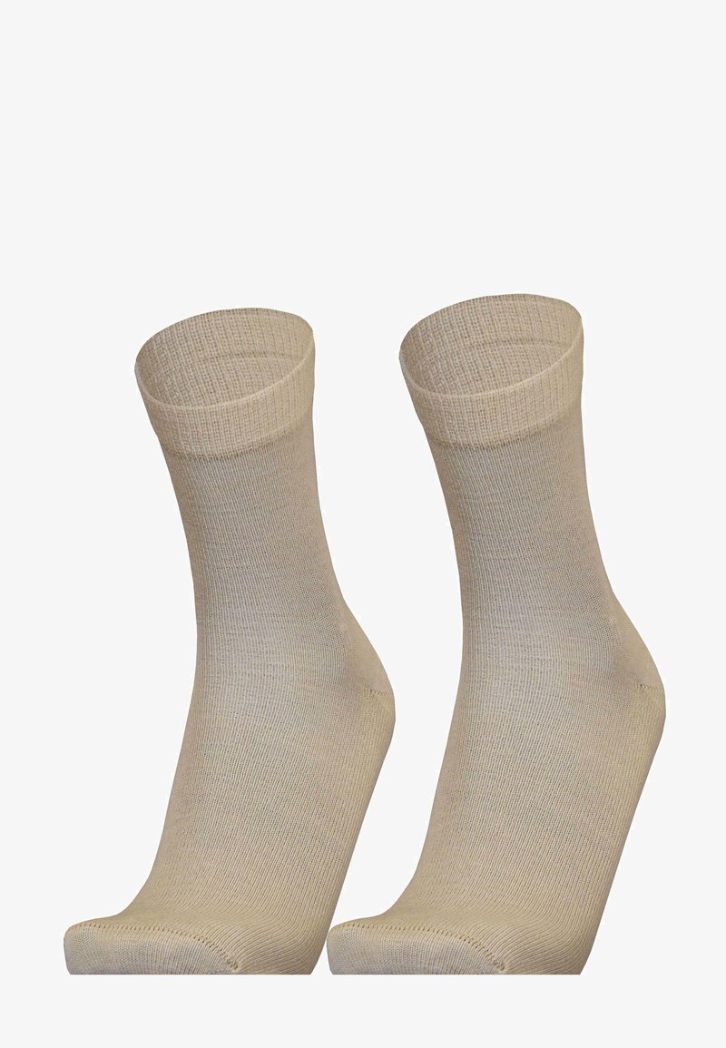 Beige socks made of a smooth, knitted material. They feature a ribbed cuff and a simple, seamless design without patterns or logos.