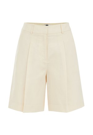 Beežid kohandatud põlveni ulatuvad lühikesed püksid esiplaatide, vööaasade ja varjatud eest kinnitusega.