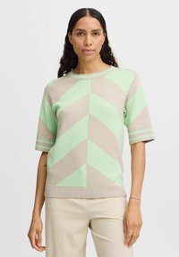 Kurzarmpullover im beige und mintgrünen Zickzackmuster, mit Rundhalsausschnitt und geripptem Saum sowie Bündchen.