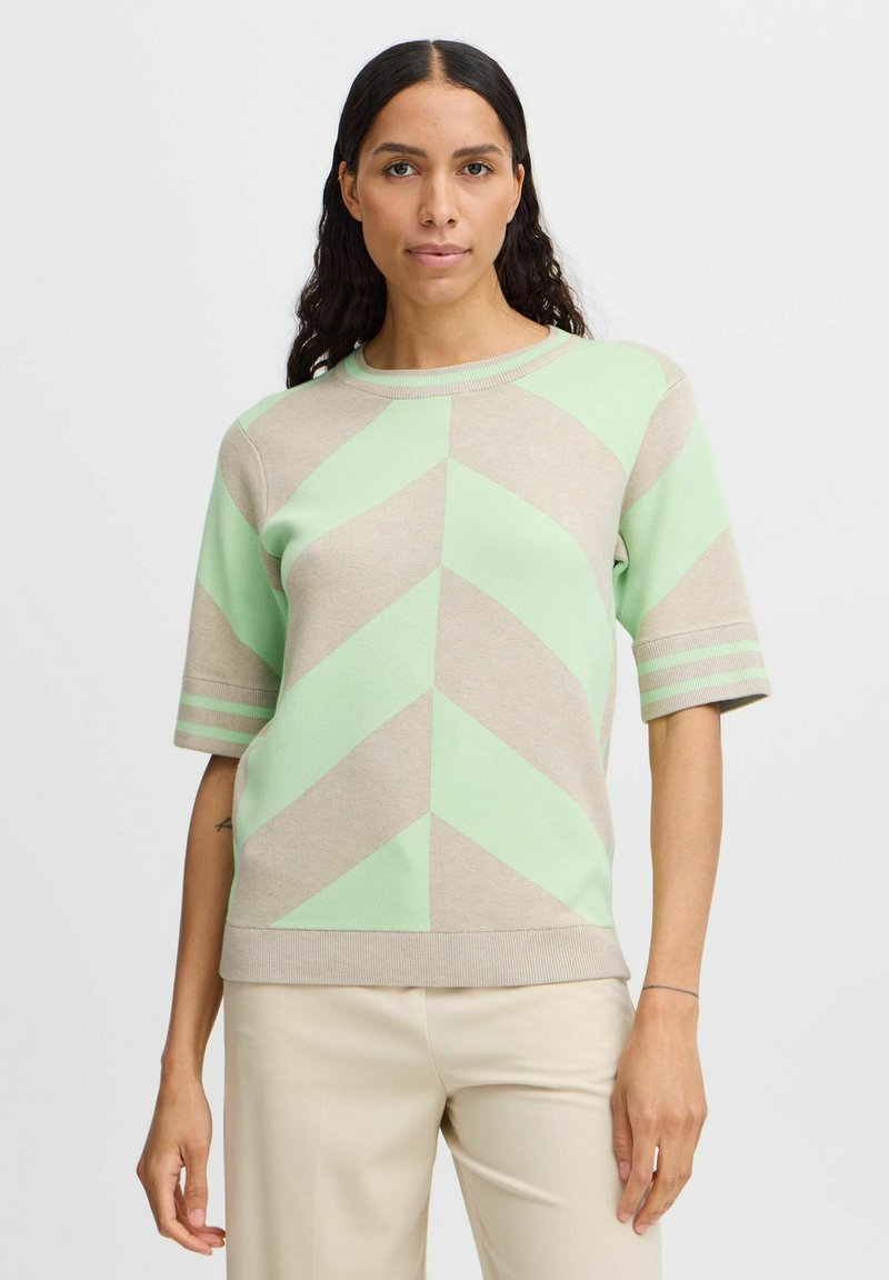 Kurzarmpullover im beige und mintgrünen Zickzackmuster, mit Rundhalsausschnitt und geripptem Saum sowie Bündchen.