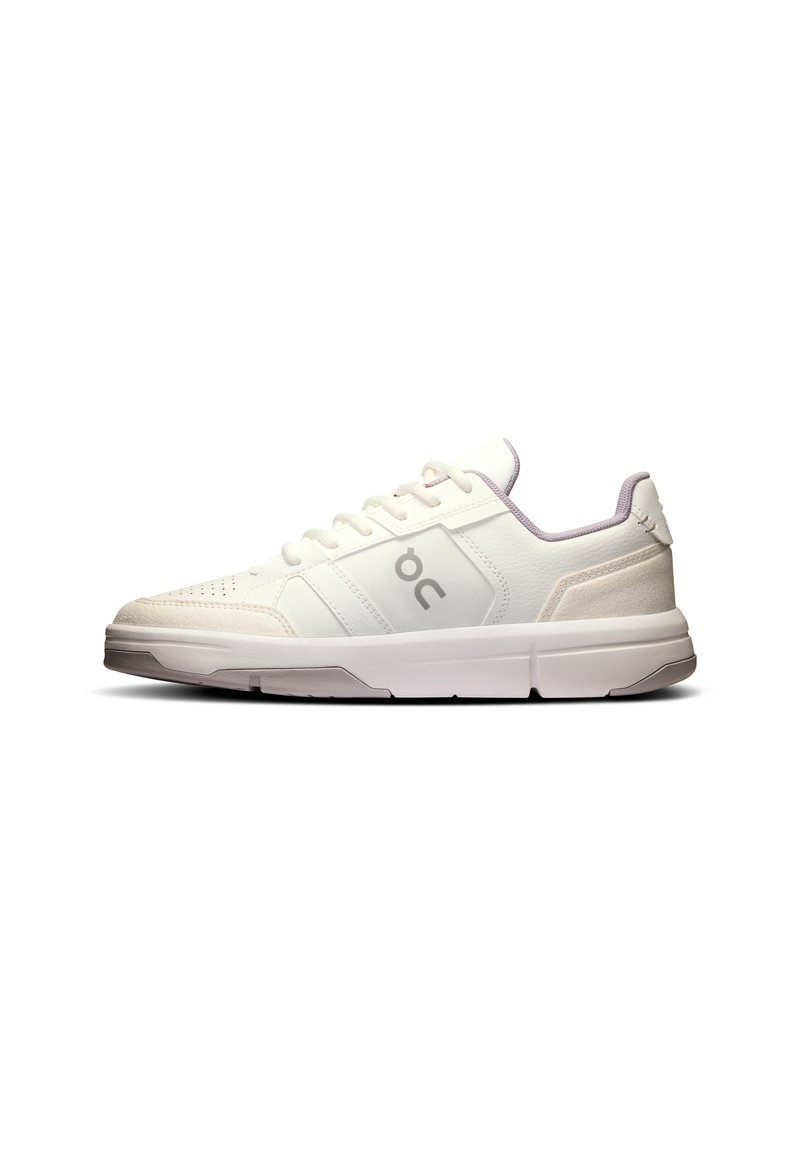White athletic sneakers featuring a textured upper, lace closure, and subtle gray accents. The sole is thick and cushioned for support.