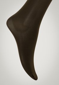 Snygga svarta strumpbyxor med en mjuk yta, med fotdesign och en subtil glans som smalnar av mot en mjuk tåfinish.