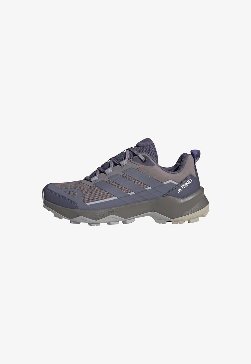Scarpe da trail running in grigio scuro e viola, con parte superiore in mesh, suola in gomma e tre strisce orizzontali come elementi di design.