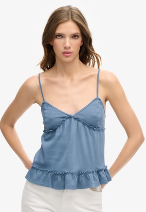 Blauw, zacht stoffen tanktop met dunne bandjes en ruches bij de buste en onderrand. Heeft een getailleerde bovenkant en een uitlopende onderkant.