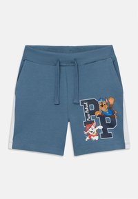 Šortsevi od plavog pamuka s mješavinom, s rebrastim pojasom, vezicom i bočnim bijelim panelima. Sadrže crteže crtanih likova i grafički dizajn "Paw Patrol".