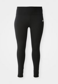 Black leggings made of stretchy material with a high waistband, featuring minimal stitching and a small white logo on the upper side.