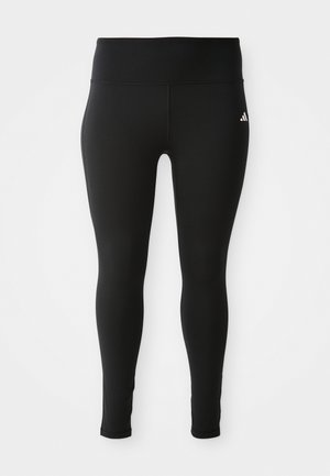 Leggings neri realizzati in materiale elastico con una vita alta, caratterizzati da cuciture minime e un piccolo logo bianco sul lato superiore.