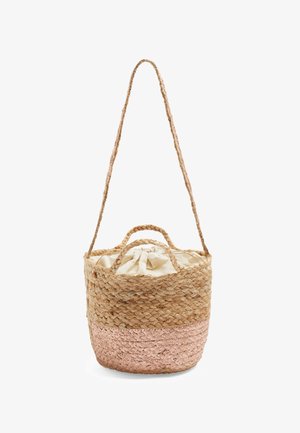 Kulatá pletená taška z přírodních a růžových vláken, s látkovým tahem na zavírání, krátkými držadly a dlouhým splétaným ramenním popruhem.