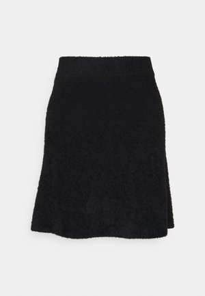 Jupe noire longueur genou avec une texture duveteuse et une taille élastique, présentée sur un fond clair uni.