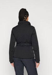 Μαύρο επενδυμένο μπουφάν με ψηλό γιακά, ραβδωτές λεπτομέρειες στο πλάι και ρυθμιζόμενη ζώνη στη μέση με ανάγλυφη σήμανση.