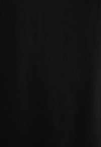 Black cotton fabric displaying a smooth texture and medium weight, without visible patterns or embellishments.