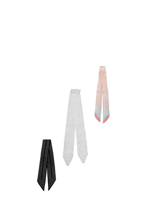Three narrow scarves hanging separately: black with white stripes, white lace with floral pattern, and pink with diagonal stripes and blue tips.