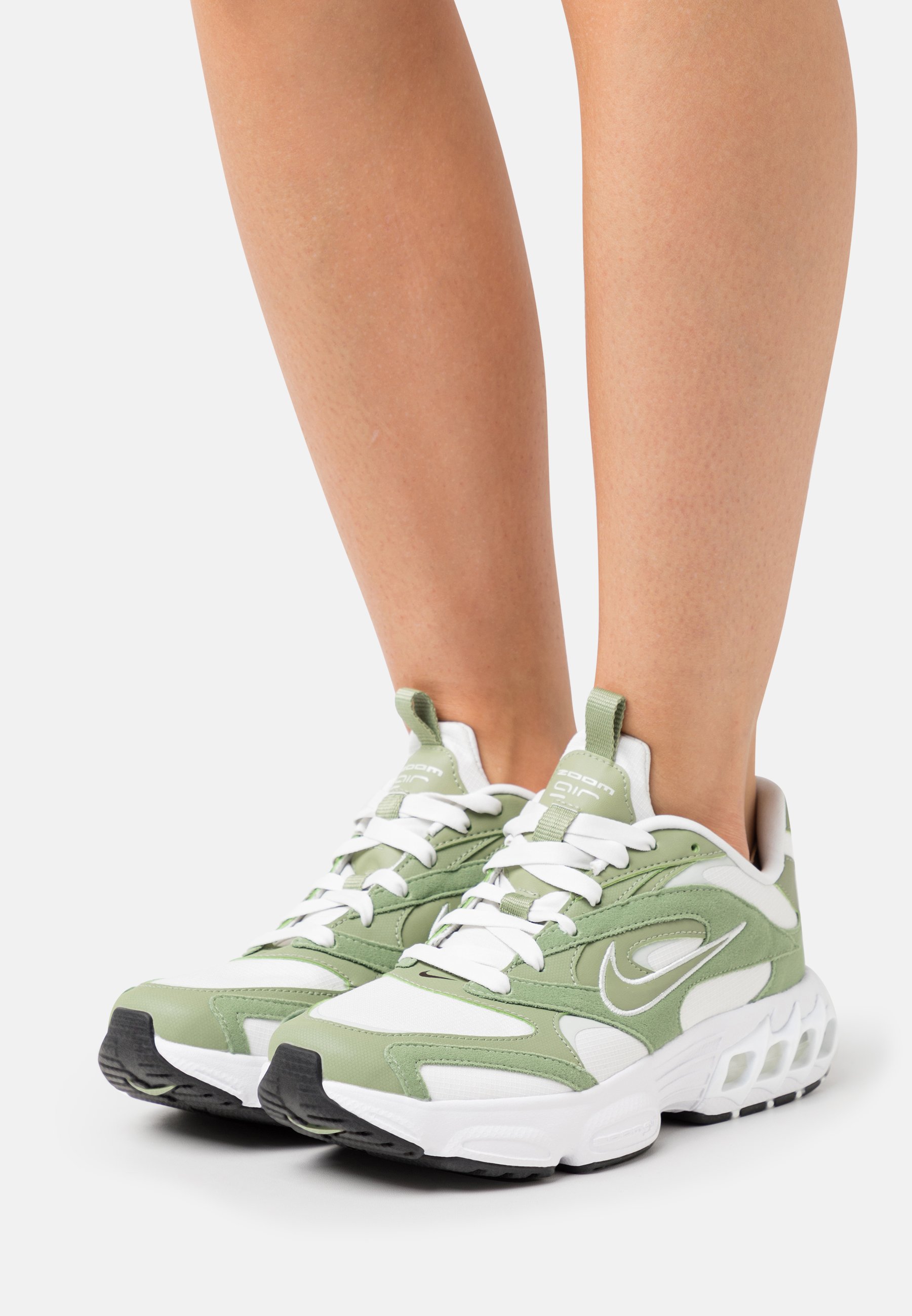white and green nike trainers