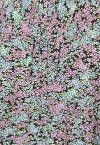 Tecido com padrão floral apresentando um fundo preto com tons pastel de rosa, azul e amarelo. A textura parece suave e lisa.