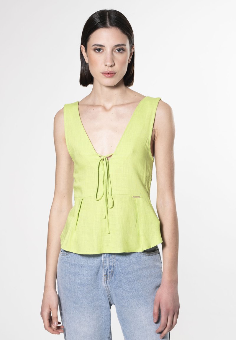 Top peplum verde lime con scollatura a V e dettaglio a fiocco sul davanti, realizzato in tessuto leggero, presenta una superficie testurizzata.