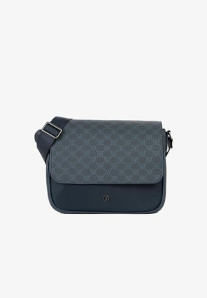 Sac bandoulière bleu foncé avec sangle réglable, fermeture à rabat ornée d'un motif répétitif de logos circulaires et d'un petit emblème métallique circulaire.