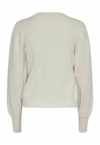 Suéter color crema con cuello redondo, mangas abullonadas y puños acanalados. Textura suave y corte relajado en un acabado liso.