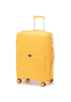 Yellow hard-shell suitcase with wave pattern, extendable handle, four roller wheels, and a side handle. Features a black logo plate.