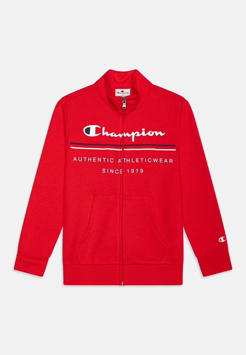 Veste Champion rouge à fermeture éclair complète avec texte de logo blanc et noir "Champion Authentic Athleticwear Since 1919" et poches avant.