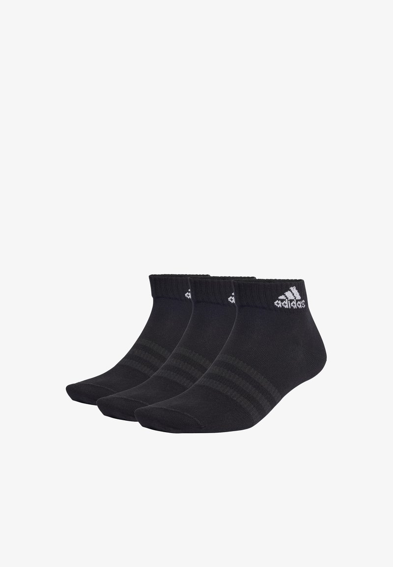 Black ankle socks with a ribbed cuff, featuring three distinctive stripes and a small logo above the cuff. Soft, stretchy fabric.
