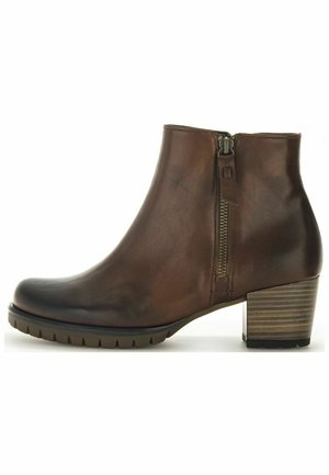 Braune Leder-Ankelstiefel mit runder Zehenform, seitlichem Reißverschluss und gestapeltem Absatz. Mit einer strukturierten Sohle für besseren Halt.