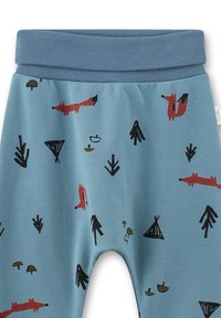 Blaue Babyhose mit einem blauen elastischen Bund, dekoriert mit roten Füchsen, schwarzen Bäumen und kleinen grünen und schwarzen Pilzen.